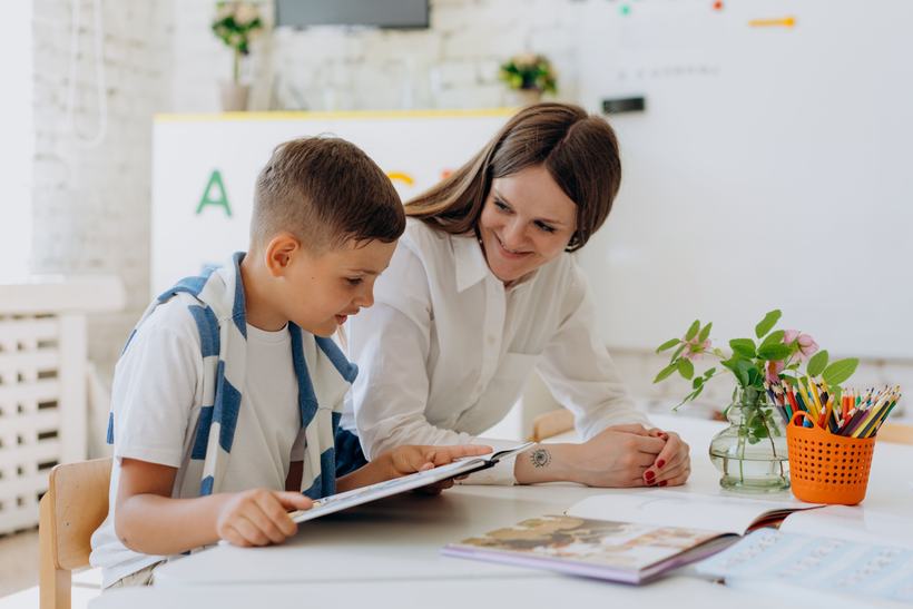 Teacher working with a student in a classroom